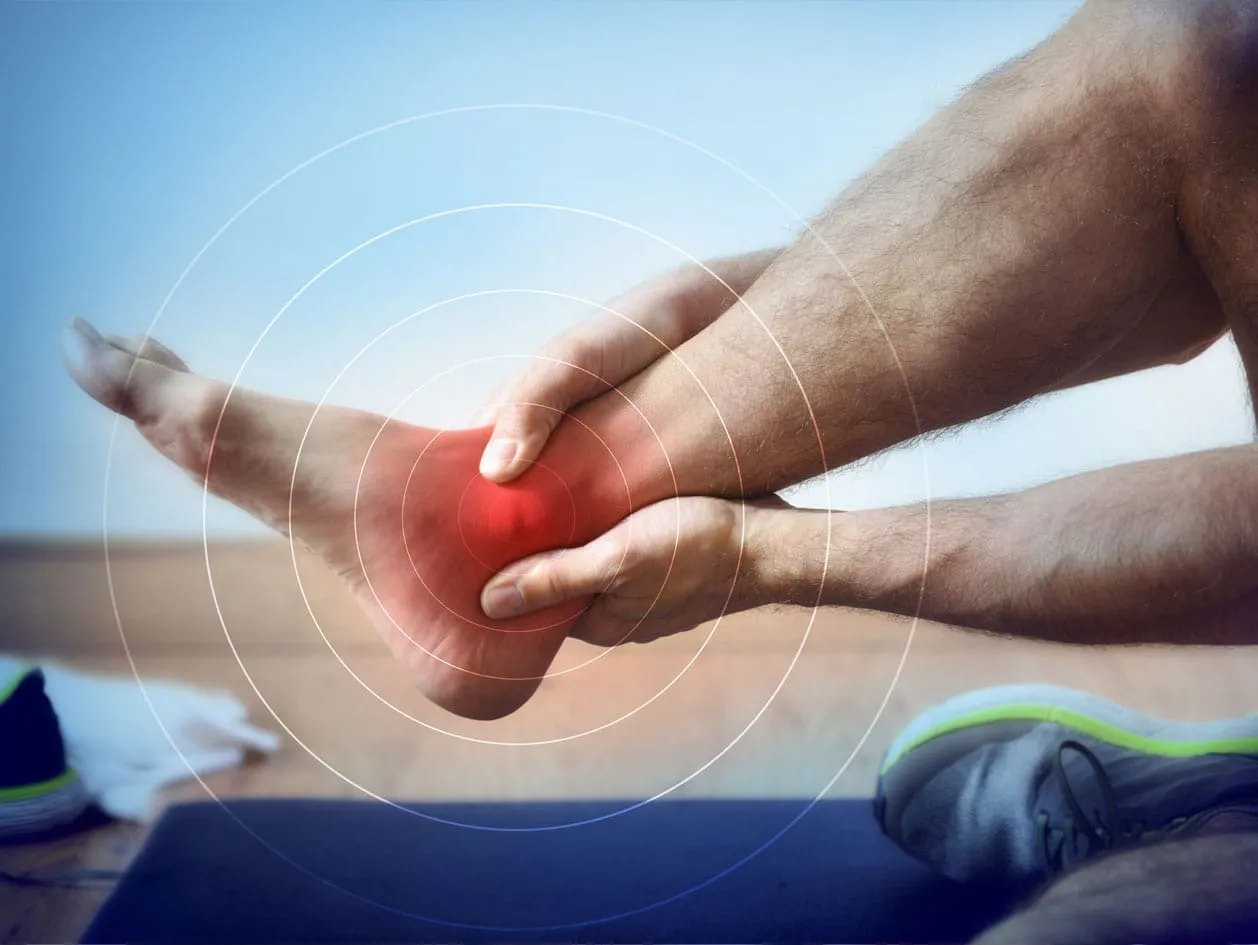 A man experiencing pain from a fractured ankle