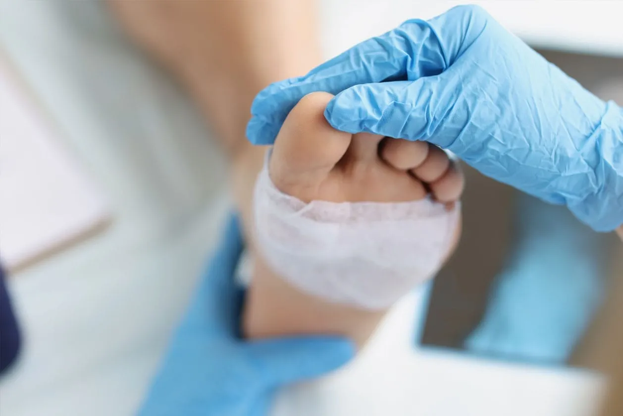 A doctor examining an ankle for injury