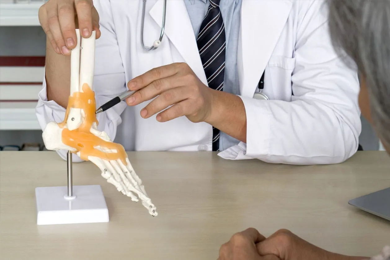 An ankle specialist doctor explaining a procedure to a patient