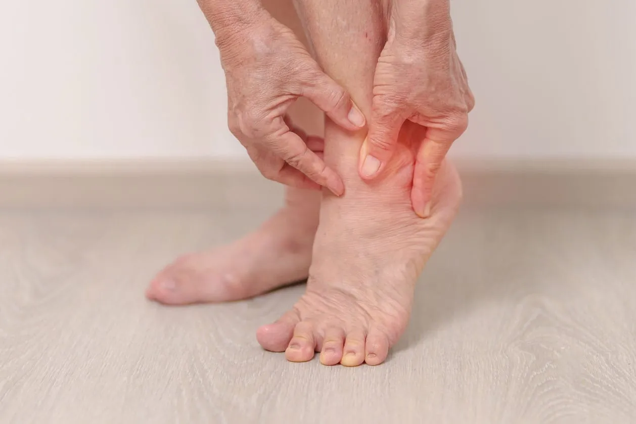 An elderly woman experiencing ankle pain